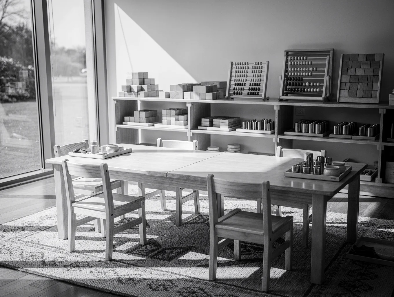 Bright Montessori classroom with natural wood furniture and educational materials
